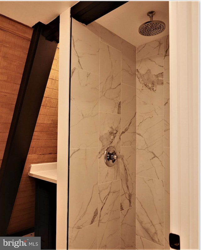 bathroom with vanity and a tile shower