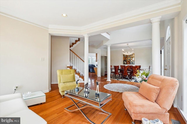 living room with ornamental molding, a notable chandelier, and wood-type flooring