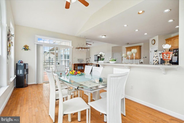 dining area featuring vaulted ceiling, light wood-type flooring, and ceiling fan