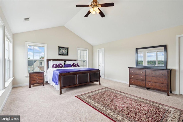 carpeted bedroom with vaulted ceiling, multiple windows, and ceiling fan