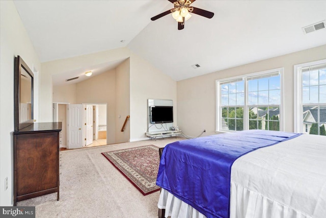 bedroom featuring ensuite bathroom, light colored carpet, high vaulted ceiling, and ceiling fan