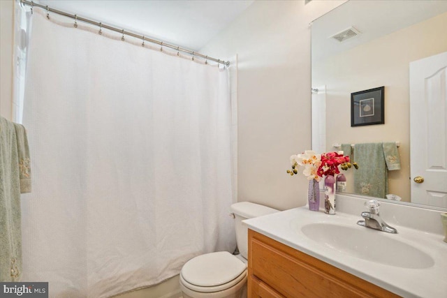 bathroom with vanity, a shower with shower curtain, and toilet