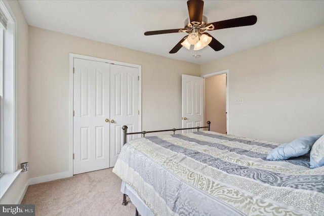 carpeted bedroom with a closet and ceiling fan