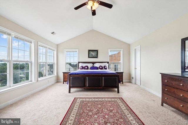 bedroom featuring multiple windows, light colored carpet, lofted ceiling, and ceiling fan