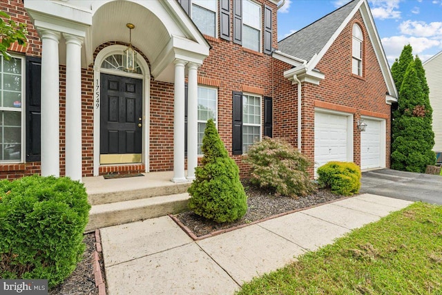 view of exterior entry with a garage