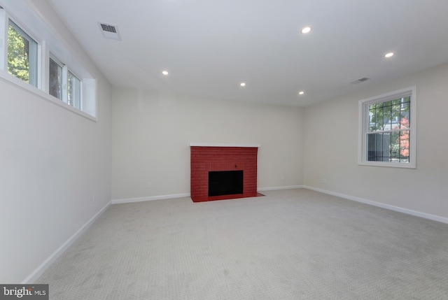 basement featuring a fireplace and light carpet