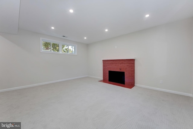 unfurnished living room with light carpet and a fireplace