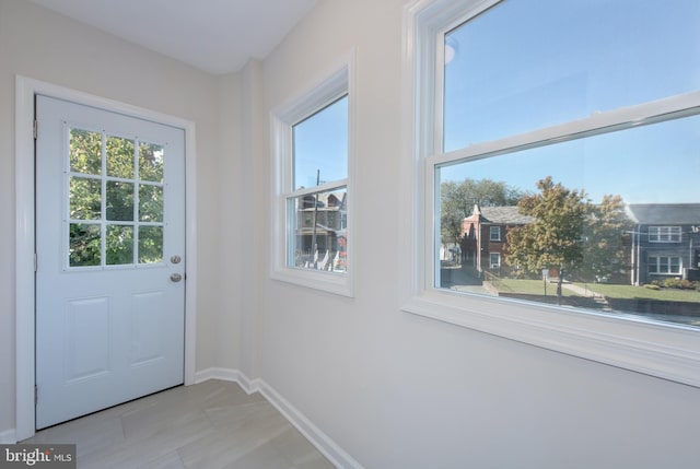 spare room with baseboards and dark wood finished floors