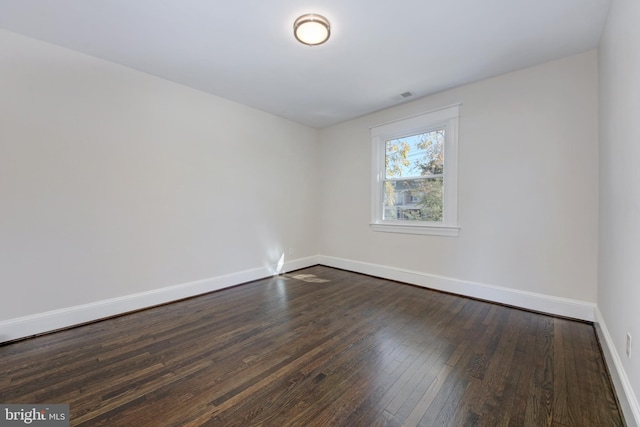 unfurnished room with dark hardwood / wood-style floors