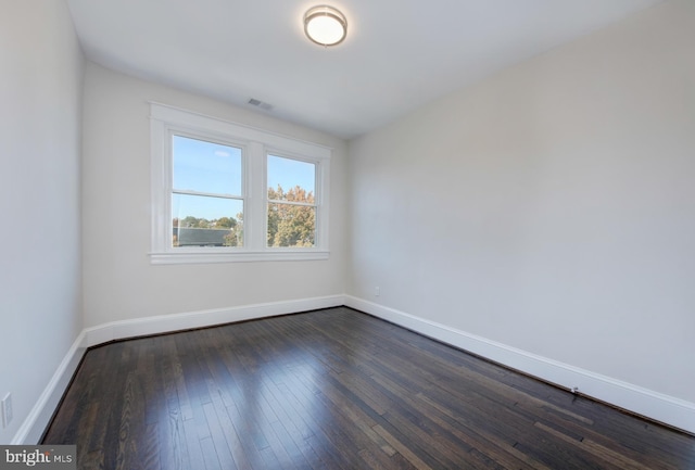 spare room with dark wood-type flooring