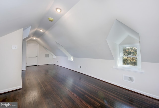 additional living space with lofted ceiling and dark wood-type flooring