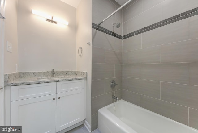 bathroom with vanity and tiled shower / bath combo