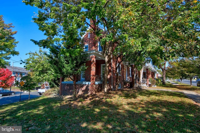 obstructed view of property featuring a front yard