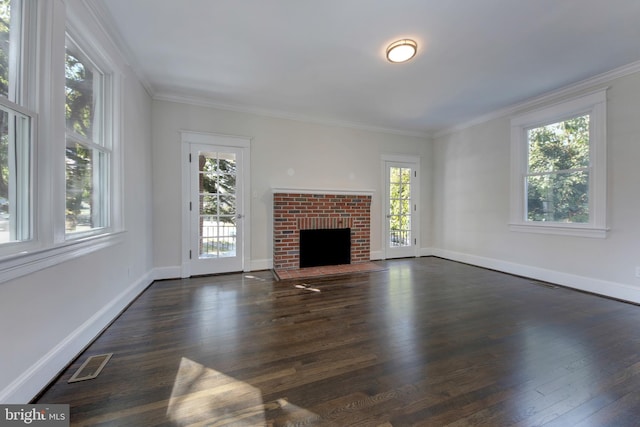 unfurnished living room featuring a fireplace, ornamental molding, a wealth of natural light, and dark wood-type flooring