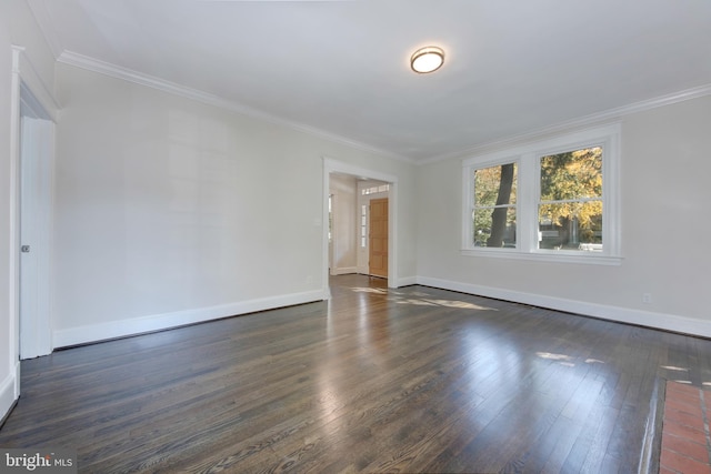 spare room featuring dark hardwood / wood-style flooring and ornamental molding