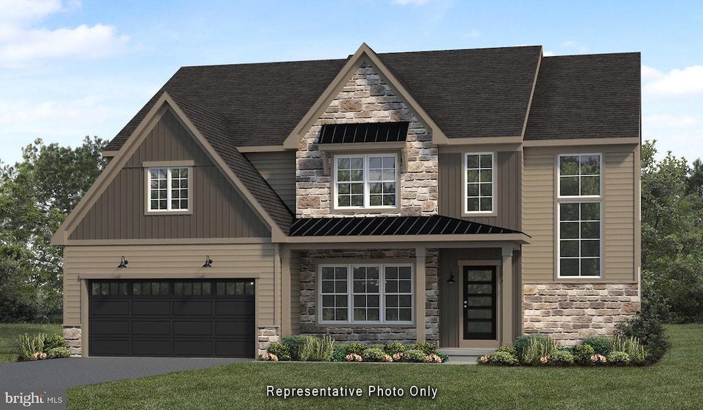 view of front of house with a garage and a front yard