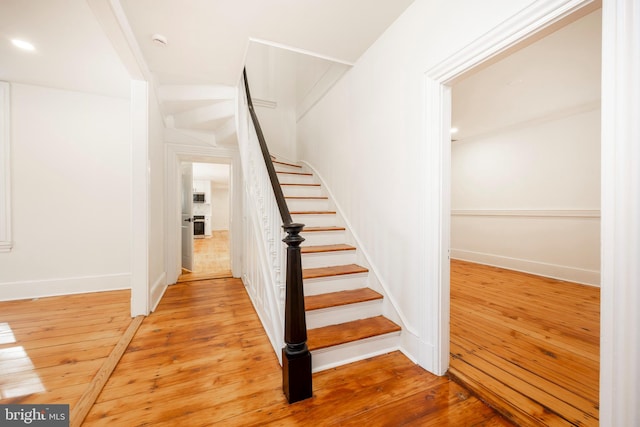 stairs featuring wood-type flooring