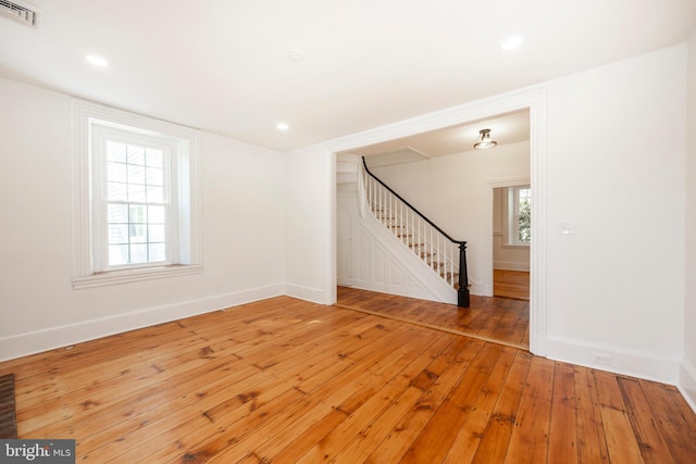 unfurnished room with hardwood / wood-style flooring