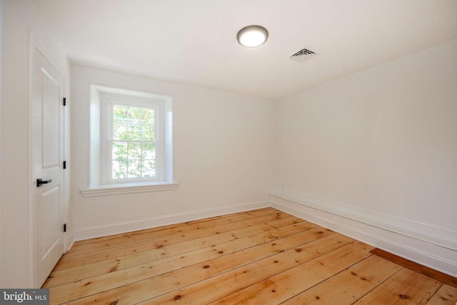 empty room with hardwood / wood-style floors