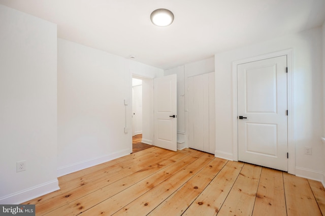 unfurnished bedroom featuring light wood-type flooring