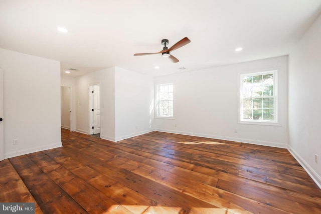 spare room featuring dark wood-type flooring and ceiling fan