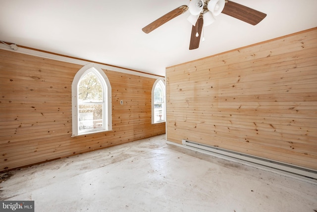 unfurnished room with a baseboard radiator, wooden walls, and ceiling fan