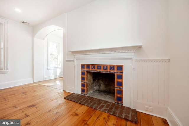 room details featuring a brick fireplace and hardwood / wood-style floors