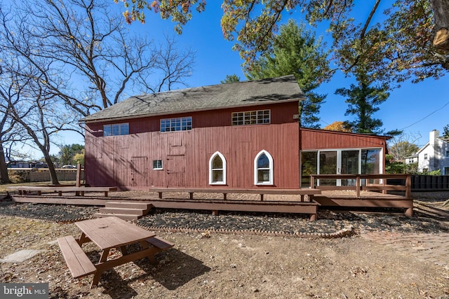 rear view of house featuring a deck