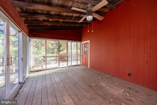 unfurnished sunroom featuring vaulted ceiling with beams, wood ceiling, and ceiling fan