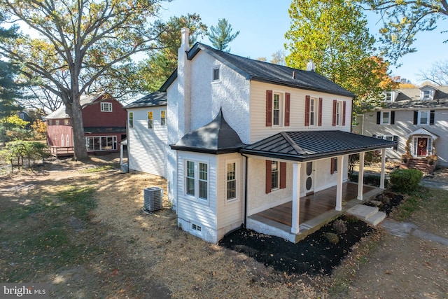 rear view of property with a porch and central AC unit