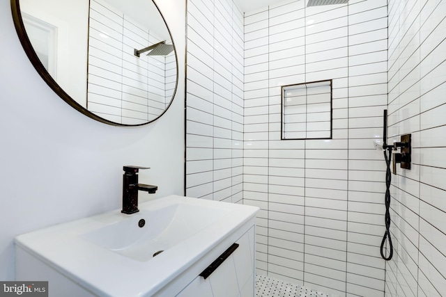 bathroom with vanity and a tile shower