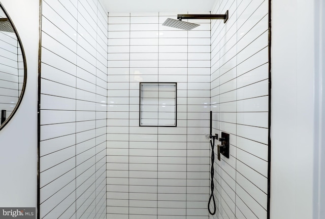 bathroom with tiled shower