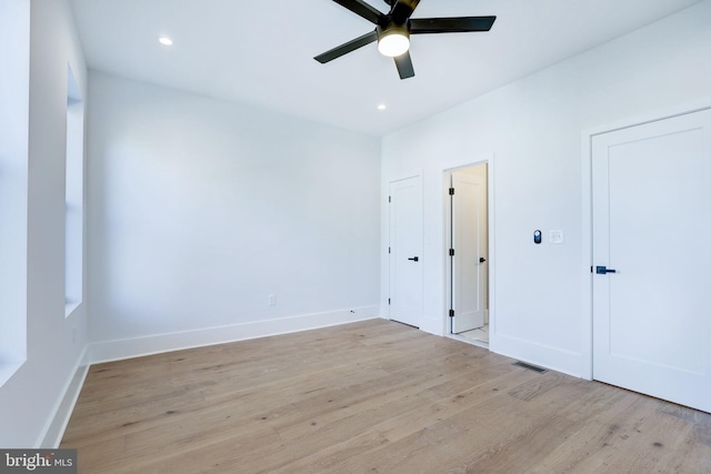 empty room with light hardwood / wood-style floors and ceiling fan