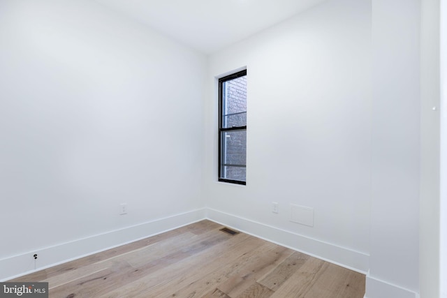 spare room featuring light wood-type flooring