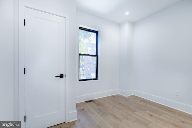 unfurnished room with light hardwood / wood-style floors