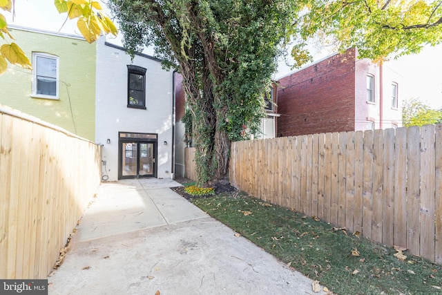 view of side of property with a patio and french doors