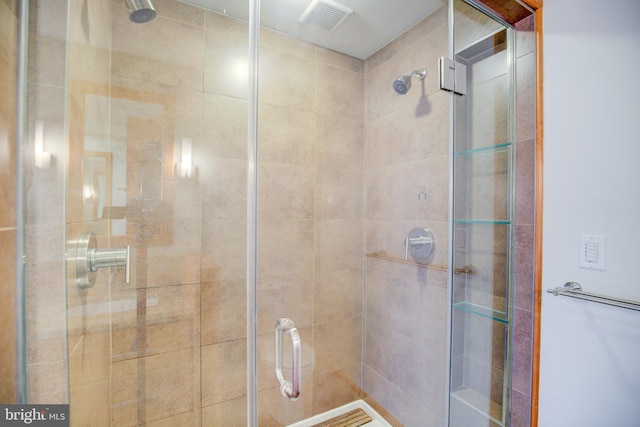 bathroom with a shower with door