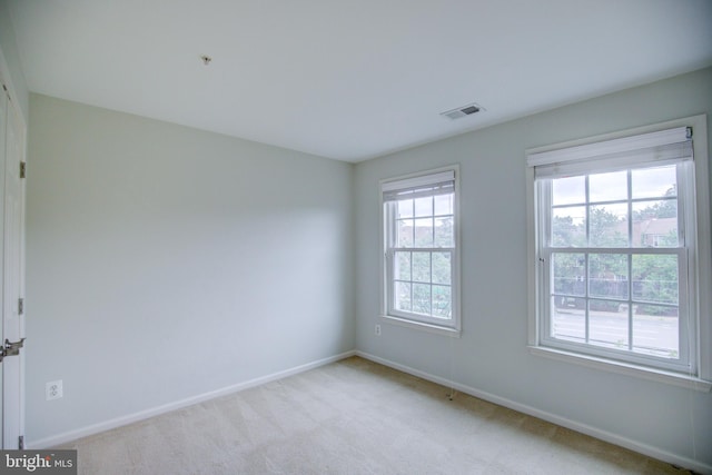 spare room with light colored carpet