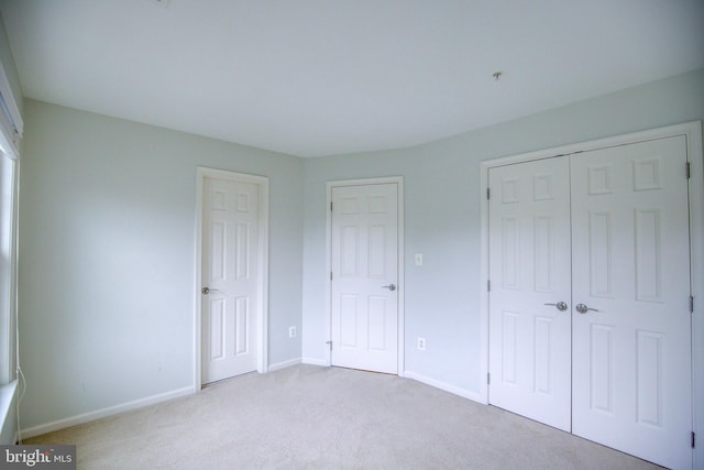 unfurnished bedroom with light carpet