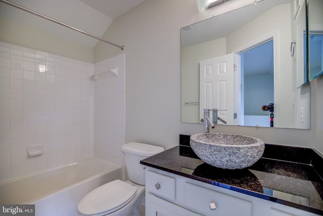 full bathroom with vanity, tiled shower / bath combo, and toilet