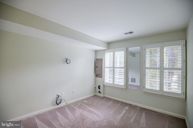 carpeted empty room featuring electric panel