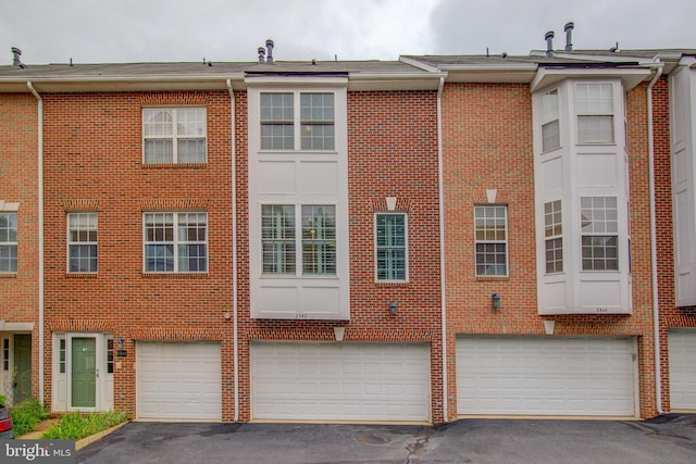 rear view of house with a garage