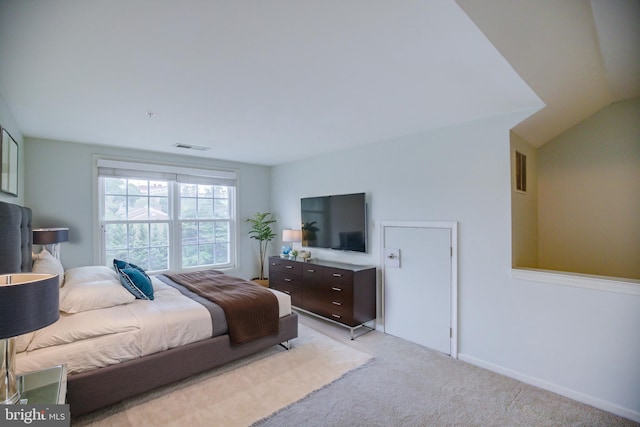 carpeted bedroom with vaulted ceiling