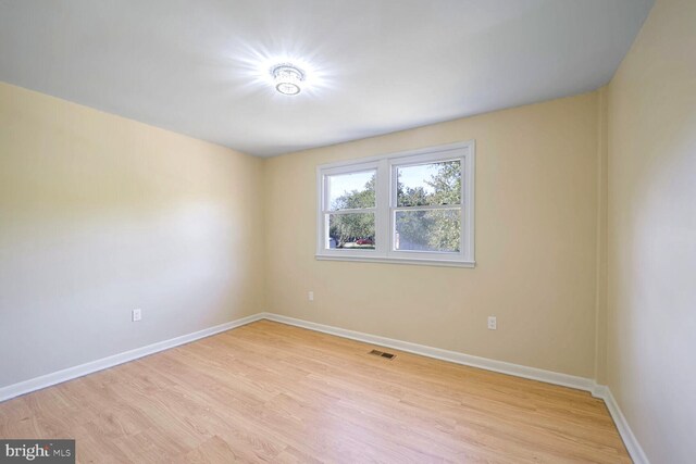 unfurnished room with light wood-type flooring