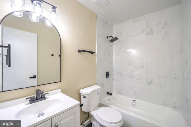 full bathroom featuring vanity, tiled shower / bath combo, and toilet