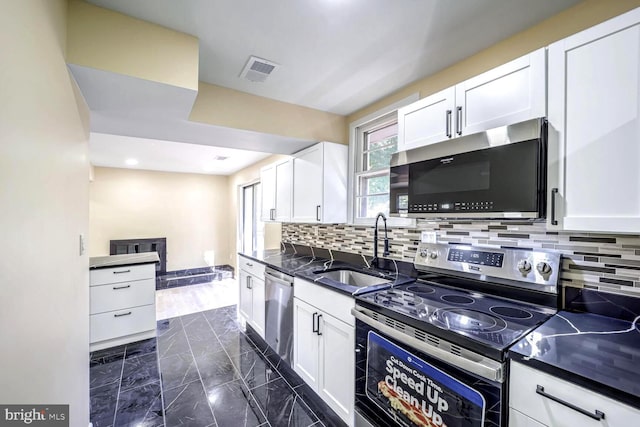 kitchen with sink, white cabinetry, and stainless steel appliances