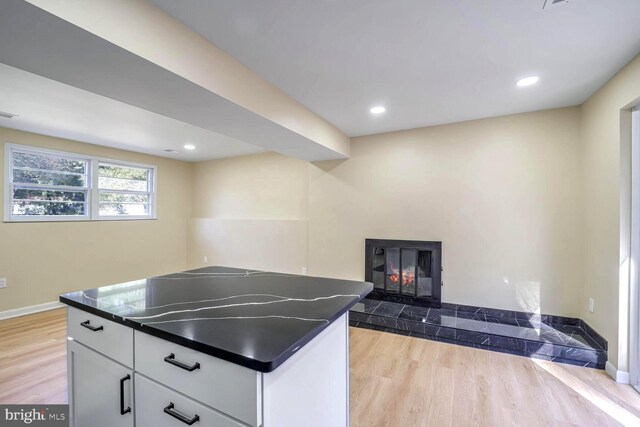 kitchen featuring light hardwood / wood-style floors and white cabinets