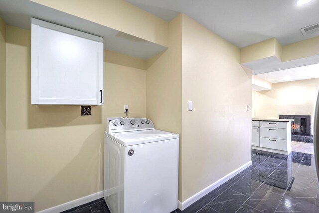 laundry area with cabinets and washer / clothes dryer