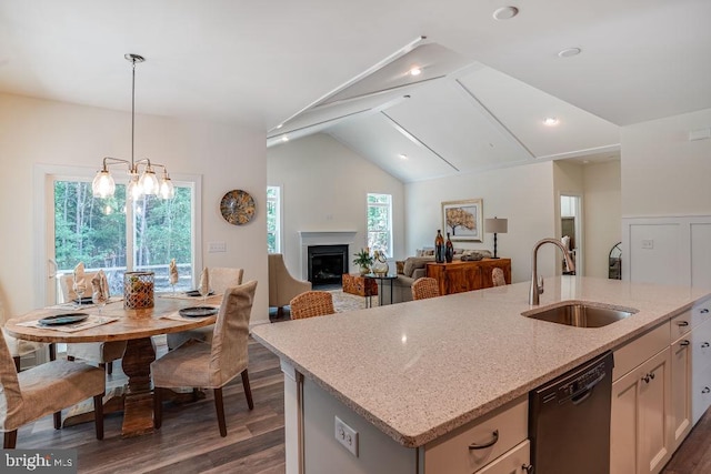 kitchen with dark hardwood / wood-style flooring, sink, a center island with sink, and black dishwasher