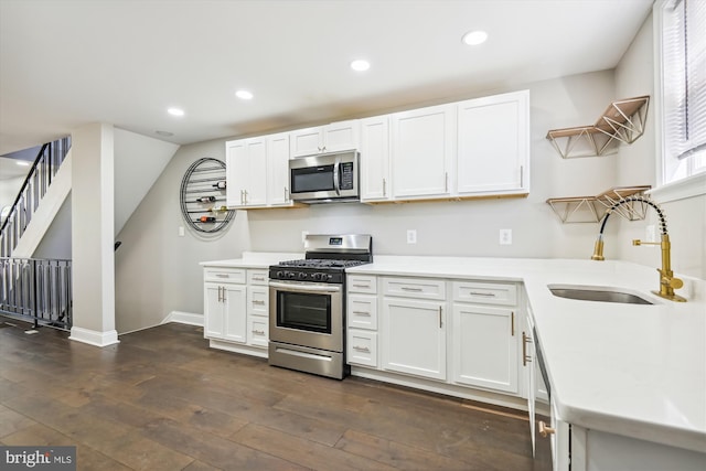 kitchen featuring sink, stainless steel appliances, dark hardwood / wood-style flooring, and white cabinets